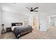 Spacious bedroom featuring neutral tones, a ceiling fan, and an ensuite bathroom at 5824 E Hoover Ave, Mesa, AZ 85206