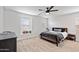 Bright bedroom featuring a ceiling fan, a comfortable bed, and natural light at 5824 E Hoover Ave, Mesa, AZ 85206