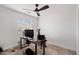 This bedroom features plush carpet, a window with blinds, and a modern ceiling fan at 5824 E Hoover Ave, Mesa, AZ 85206