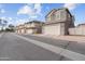 Street view of newly constructed townhomes with attached garages and well-maintained landscaping at 5824 E Hoover Ave, Mesa, AZ 85206