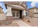 Inviting front porch featuring stone accents, covered entry, and a secure Safeguard security system at 5824 E Hoover Ave, Mesa, AZ 85206