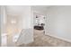 Upstairs hallway leading to a bedroom with an open doorway, carpet floors, and white walls at 5824 E Hoover Ave, Mesa, AZ 85206