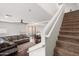 Cozy living room featuring a ceiling fan, a comfortable sofa, and a staircase at 5824 E Hoover Ave, Mesa, AZ 85206