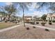 Community playground with a slide and canopy surrounded by trees and residential houses at 5824 E Hoover Ave, Mesa, AZ 85206