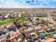 Expansive aerial view of a neighborhood with a golf course, lake, and mountain views, ideal for Gathering living at 6118 E Star Valley St, Mesa, AZ 85215