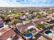 Picturesque aerial shot of a residential area, featuring homes with pools and proximity to a golf course and lake at 6118 E Star Valley St, Mesa, AZ 85215