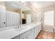 Spacious bathroom featuring double sinks, a large mirror, and ample counter space at 6118 E Star Valley St, Mesa, AZ 85215