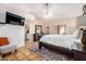 Serene bedroom with a large bed, natural light, and a doorway leading to an ensuite bathroom at 6118 E Star Valley St, Mesa, AZ 85215