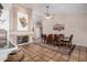 Formal dining room showcasing a long wooden table, a fireplace, and terra cotta tile flooring at 6118 E Star Valley St, Mesa, AZ 85215