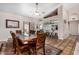 Elegant dining room with a wooden table, a ceiling fan, and views into the kitchen area at 6118 E Star Valley St, Mesa, AZ 85215