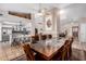 Open-concept dining room featuring a long table, fireplace, and seamless transition to the kitchen at 6118 E Star Valley St, Mesa, AZ 85215