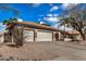 Charming single-story home with a three-car garage and desert landscaping at 6118 E Star Valley St, Mesa, AZ 85215