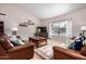 Cozy living room featuring tile flooring, leather sofas, and a large window at 6118 E Star Valley St, Mesa, AZ 85215