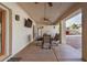 Covered patio featuring a dining table, chairs, and a ceiling fan for outdoor enjoyment at 6118 E Star Valley St, Mesa, AZ 85215