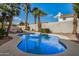 Inviting backyard pool surrounded by palm trees, lounge chairs, and a privacy fence at 6118 E Star Valley St, Mesa, AZ 85215