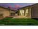 Yard view from side has a decorative flower bush, small patch of grass and concrete patio at 619 E Jensen St # 80, Mesa, AZ 85203