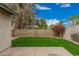 Fenced backyard with a combination of mature trees, decorative shrubs and a well manicured lawn at 619 E Jensen St # 80, Mesa, AZ 85203