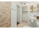 Bright bathroom featuring a white sink vanity, tiled floors, and walk-in closet at 619 E Jensen St # 80, Mesa, AZ 85203