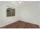 Bedroom featuring a ceiling fan, hardwood floors, and window with neighborhood views at 619 E Jensen St # 80, Mesa, AZ 85203