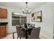 Inviting dining area with stylish chandelier, seating for four, and neutral decor at 619 E Jensen St # 80, Mesa, AZ 85203