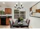 Cozy dining area features elegant chandelier, neutral color palette and backyard view at 619 E Jensen St # 80, Mesa, AZ 85203