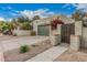 Exterior shot of stucco house with a two-car garage, gated entry, and drought-tolerant landscaping at 619 E Jensen St # 80, Mesa, AZ 85203