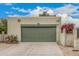 Image displays the front of a stucco house, featuring a garage, desert landscaping, and bougainvillea at 619 E Jensen St # 80, Mesa, AZ 85203