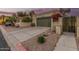 View of a home's one car garage with desert landscaping, spacious driveway and front gate at 619 E Jensen St # 80, Mesa, AZ 85203