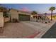 View of a home's one car garage with charming desert landscaping and spacious driveway at 619 E Jensen St # 80, Mesa, AZ 85203