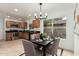 Bright kitchen featuring stainless steel appliances, wood cabinetry, and dining area at 619 E Jensen St # 80, Mesa, AZ 85203