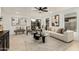 Modern living room featuring a neutral palette, contemporary decor, a ceiling fan, and ample natural light at 619 E Jensen St # 80, Mesa, AZ 85203