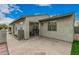 Exterior view of home featuring a concrete patio, plants, and a sliding glass door leading into the home at 619 E Jensen St # 80, Mesa, AZ 85203