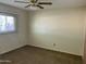 Simple bedroom with a ceiling fan and a window, offering a blank canvas at 6437 W Devonshire Ave, Phoenix, AZ 85033