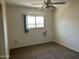 Neutral bedroom featuring a ceiling fan, carpet flooring and a window with blinds at 6437 W Devonshire Ave, Phoenix, AZ 85033