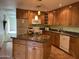 Stylish kitchen showcasing an island, wood cabinets, and modern lighting fixtures at 6437 W Devonshire Ave, Phoenix, AZ 85033