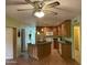 Open kitchen with a center island, wood cabinets, and bright lighting at 6437 W Devonshire Ave, Phoenix, AZ 85033