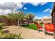 Backyard featuring gravel, artificial turf, a sitting area and a brick wall at 6634 S Pinnacle Ct, Chandler, AZ 85249