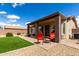 Backyard featuring artificial turf, brick pavers, and covered patio with outdoor seating at 6634 S Pinnacle Ct, Chandler, AZ 85249