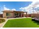 Backyard featuring artificial turf, brick pavers, and covered patio with outdoor seating at 6634 S Pinnacle Ct, Chandler, AZ 85249