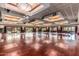 Large ballroom with wood floors, elegant lighting, and sliding glass doors to the outside patio at 6634 S Pinnacle Ct, Chandler, AZ 85249