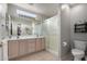 Bathroom featuring double sinks, tile floor, and a large mirror with lighting above it at 6634 S Pinnacle Ct, Chandler, AZ 85249