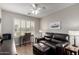 Bedroom with a ceiling fan, window with shutters, desk, and leather sofa at 6634 S Pinnacle Ct, Chandler, AZ 85249