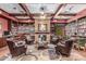 Relaxing library with stone fireplace, wood beams and shelves filled with books at 6634 S Pinnacle Ct, Chandler, AZ 85249