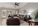 Inviting living room with a sectional sofa, a ceiling fan, and bright natural lighting at 6634 S Pinnacle Ct, Chandler, AZ 85249