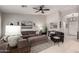 Spacious living room featuring a comfortable sectional sofa, ceiling fan, and neutral color palette at 6634 S Pinnacle Ct, Chandler, AZ 85249