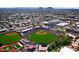 Aerial view of a baseball stadium surrounded by neighborhood, parking, and green fields at 6702 E Monte Vista Rd, Scottsdale, AZ 85257