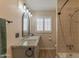 Bathroom with stone vanity, shower over tub and ample lighting at 6702 E Monte Vista Rd, Scottsdale, AZ 85257