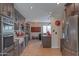 Bright, open kitchen featuring stainless steel appliances, granite countertops, and wood flooring at 6702 E Monte Vista Rd, Scottsdale, AZ 85257