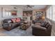 Open concept living room with leather sofas, wood flooring, and a modern kitchen area at 6702 E Monte Vista Rd, Scottsdale, AZ 85257