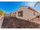 Wide angle of the backyard showcasing the side of the house with an ample area ready to be landscaped at 6915 S Sapphire Way, Chandler, AZ 85249